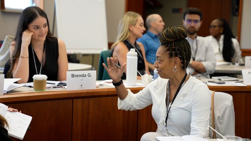 Two participants discuss a prompt in a Harvard Professional & Executive Development program taught by Michael McCarthy